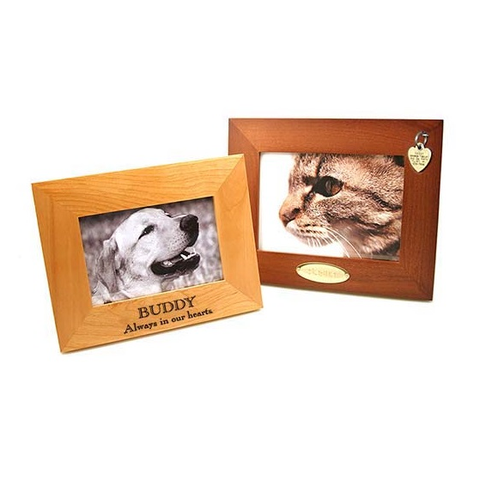 natural finish picture frame with pet name and message engraved on the frame, and a walnut finish picture frame with engraved brass plaque attached