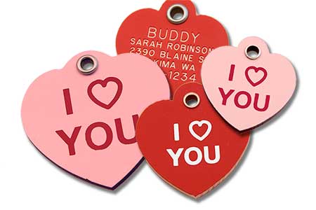 Red and pink heart shaped pet tags with I Heart You stamped on the front and engraving on the back