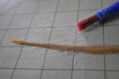 Straw on a grid with a paintbrush