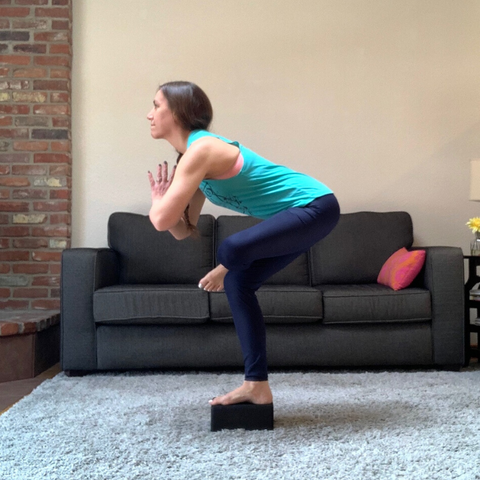 standing figure 4 balance pose with yoga block for stability and strength