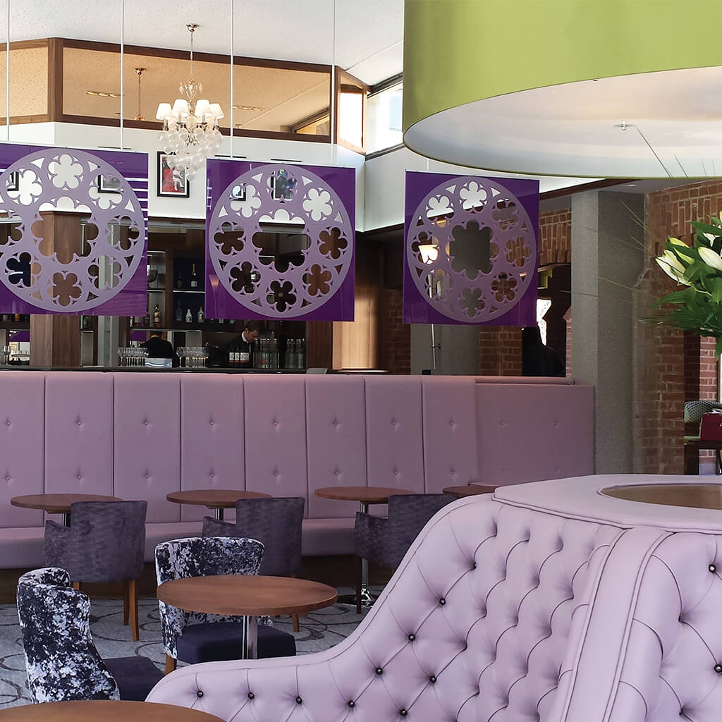 Bespoke banquette seating in purple faux leather with waterfall arms