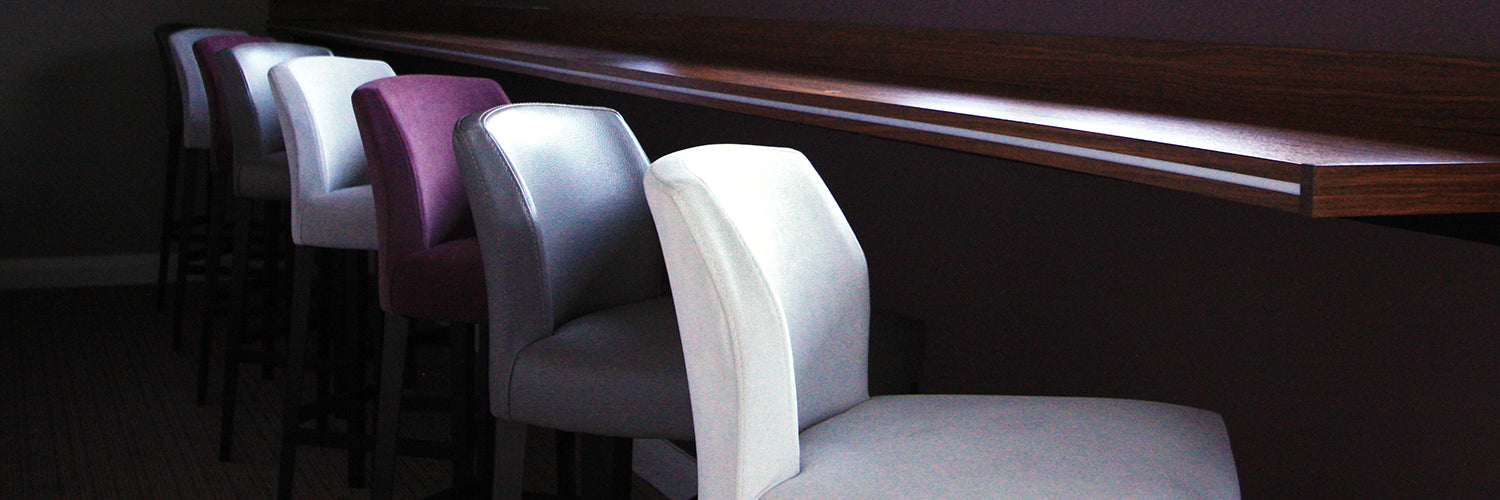 Bar Stools Lined up against a Poseur Table