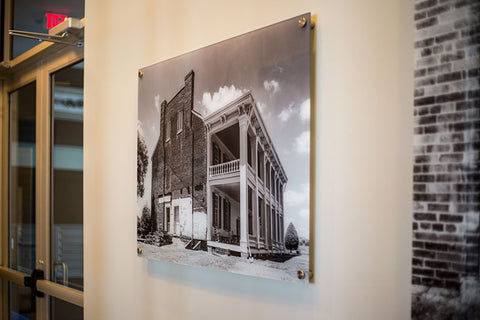 A black and white photograph of Carnton Plantation house, on the wall at Artessa at Franklin.