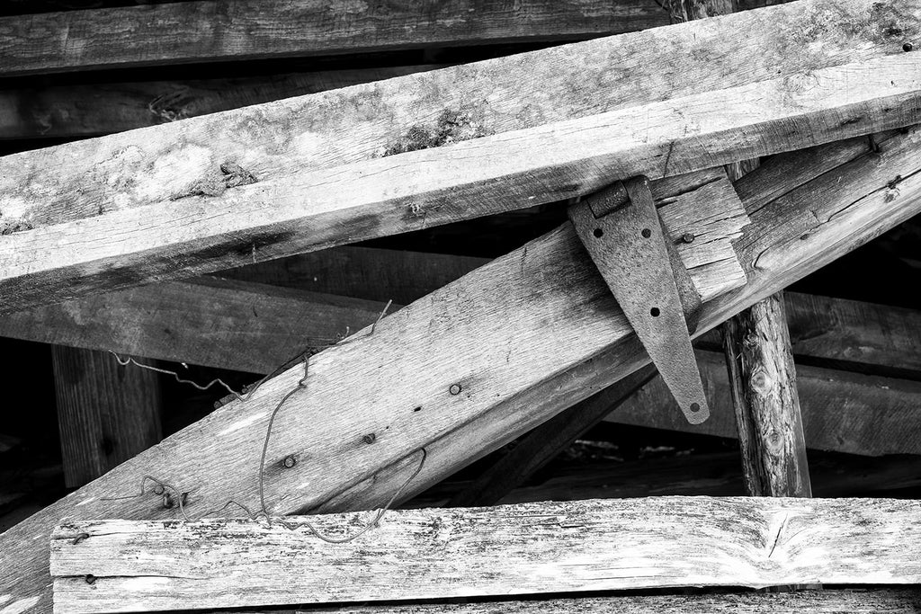 Wooden beams from a fallen barn. Black and white photograph by Keith Dotson.