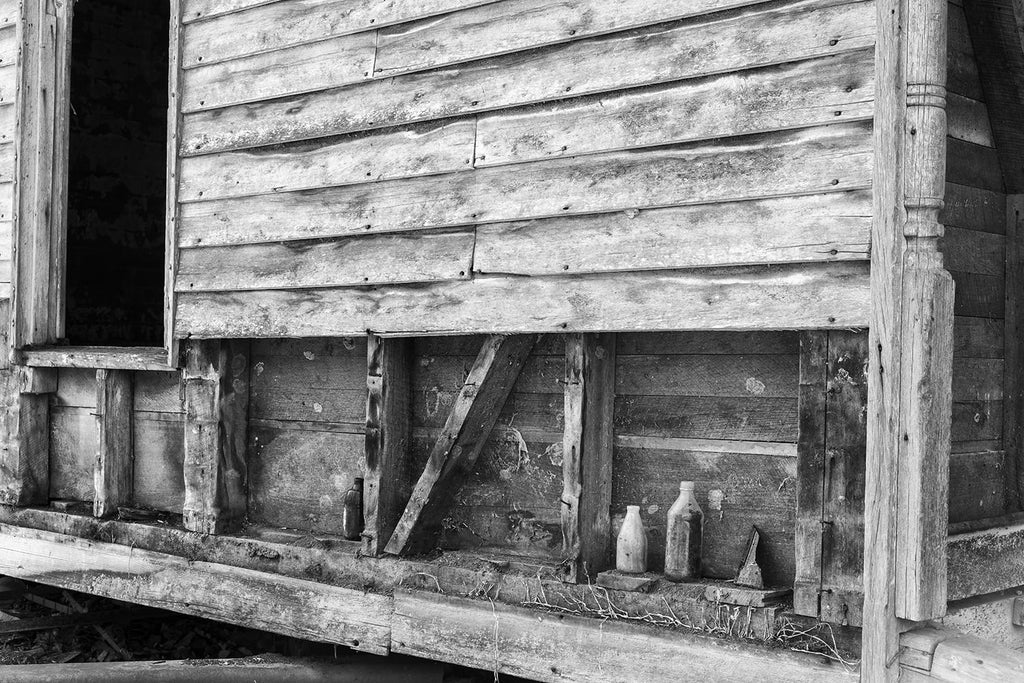 Row of Bottles on an Abandoned Farmhouse: Black and White Photograph by Keith Dotson. Click to buy a fine art print.