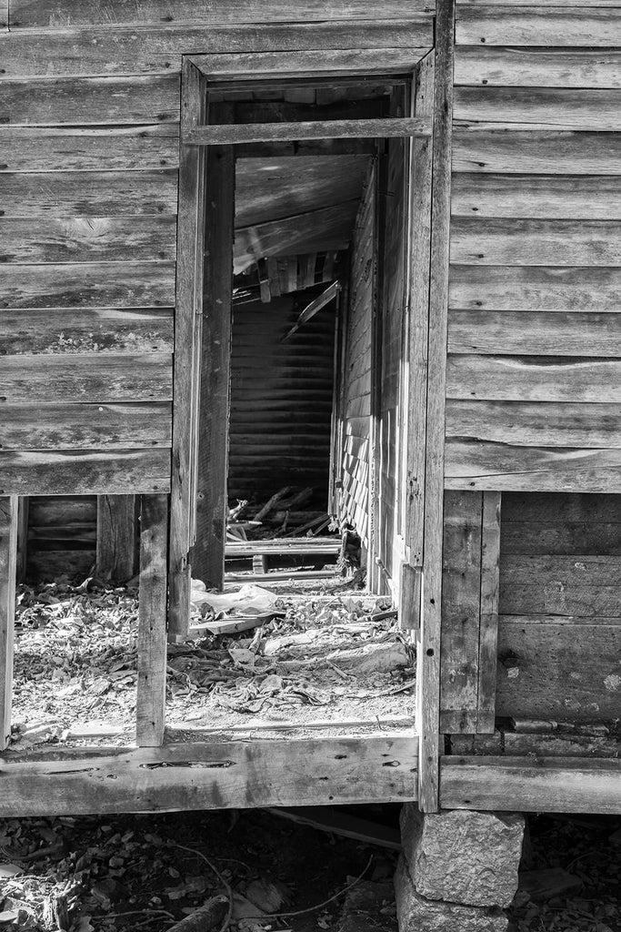 Row of door frames on the abandoned farmhouse. Black and white photograph by Keith Dotson.