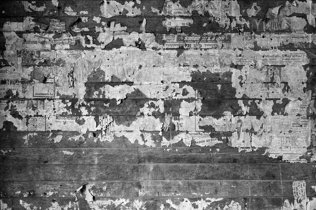 Newspapers pasted like wallpaper, found on the walls of an abandoned farmhouse. Fine art photograph by Keith Dotson.