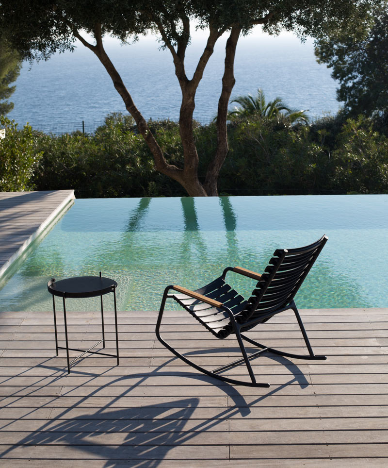 HOUE ReCLIPS Rocking Chair with bamboo armrests on poolside deck