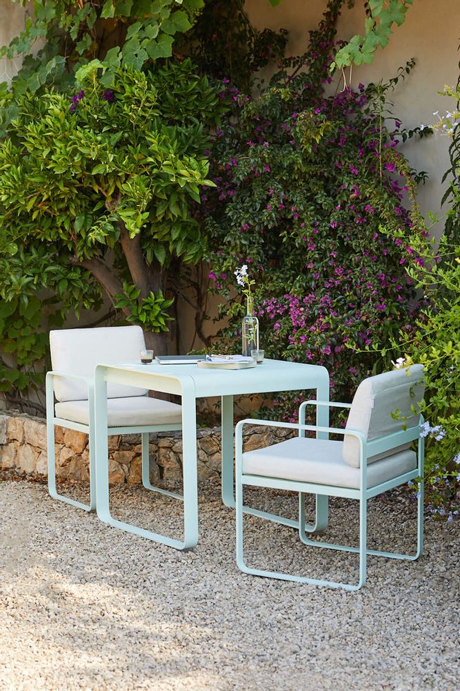 2 Fermob Bellevie Dining Armchairs with Fermob Bellevie Dining Table outside