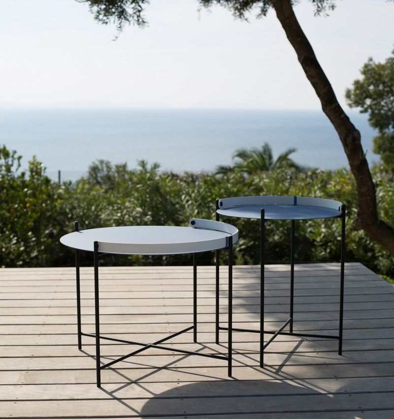 HOUE Edge Small and Medium Tray Tables on deck with view of ocean