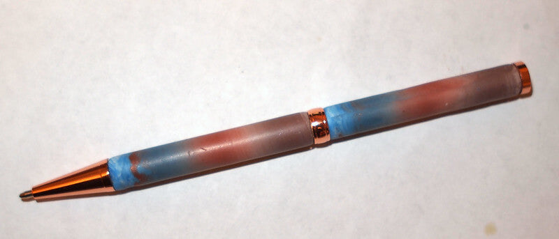 thin copper pen with blue spots close up view