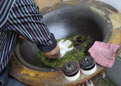 Lung Ching Dragonwell tea being pressed dry by a tea master