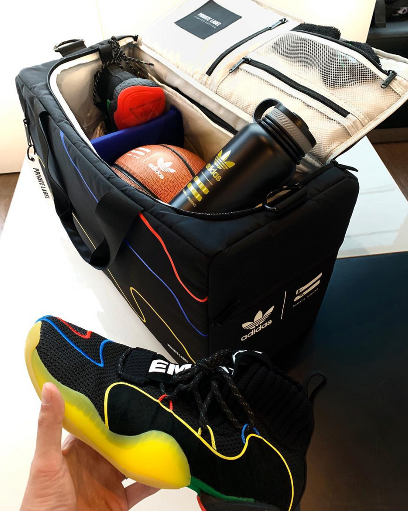 private label duffle filled with basketball water bottle and trainers