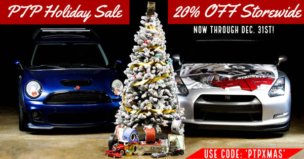 PTP's Holiday Sale is going on now! Our shop Mini Cooper and our shop Nissan GT-R flank a white Christmas tree decorated in PTP style, with our favorite PTP gifts under the tree! 
