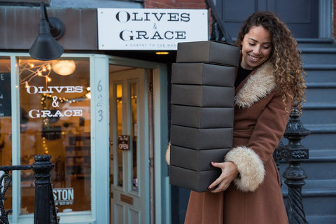 Sofi Madison at Olives & Grace Store Front Carrying Boxes