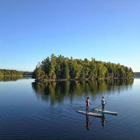 Stand up paddle boarding on a calm lake