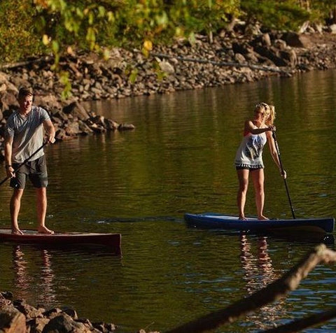 A couple stand up paddle boarding on Cruiser SUP stand up paddle boards