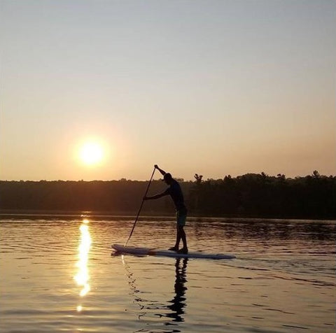 Stand up paddle boarding on a Cruiser SUP paddle board at sunset