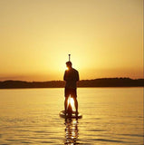 stand up paddle boarding at sunset