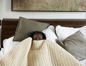 Woman Laying in Bed for Stress Relief