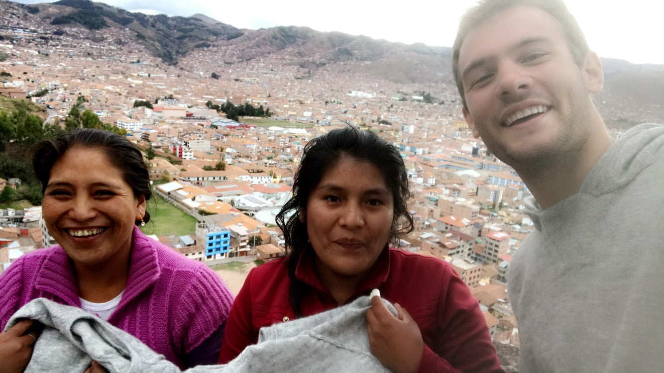 Kris Cody with two women weavers overlooking Cusco, Peru