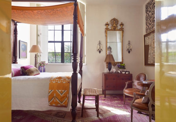 Amelia Handegan designed this room with an American poster bed with an antique Fortuny panel 