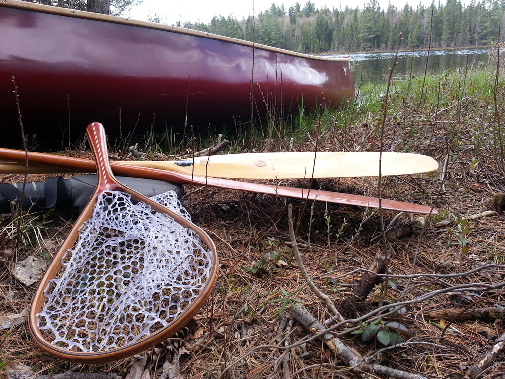 Tailwater Outdoors premium quality classic style fishing nets, handmade from high quality woods. Ideal for all fishing and outdoor enthusiasts. Shot of net with canoe and paddles