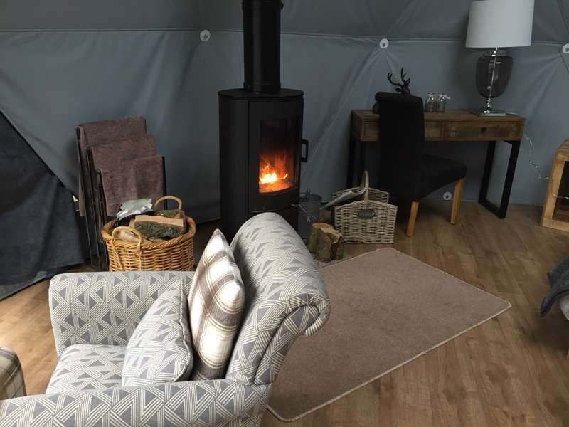 Woodland Escapes Geodome and wood burning stove on Cool Camping