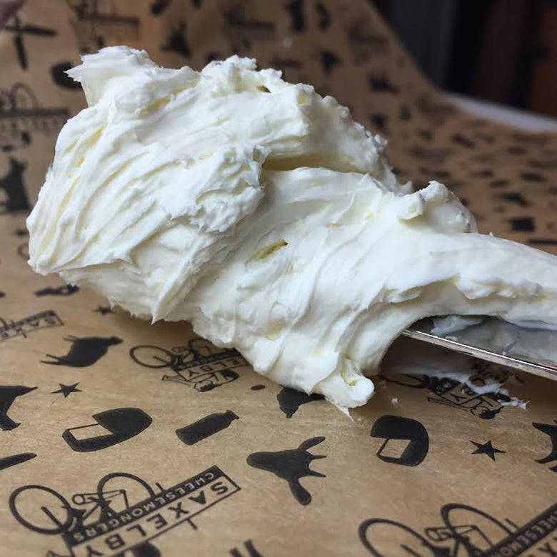 Large dollop of fresh cream cheese on waxed paper