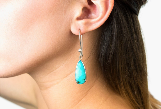 Turquoise earrings dangle on long sterling silver hooks