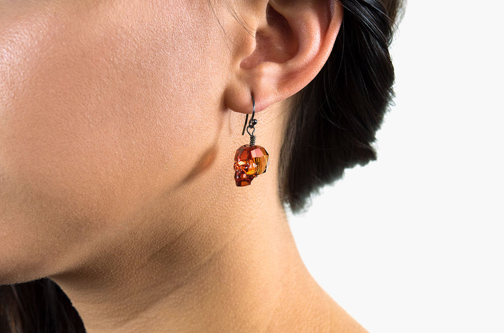 The Swarovski skull earring is available in stunning red magma crystal