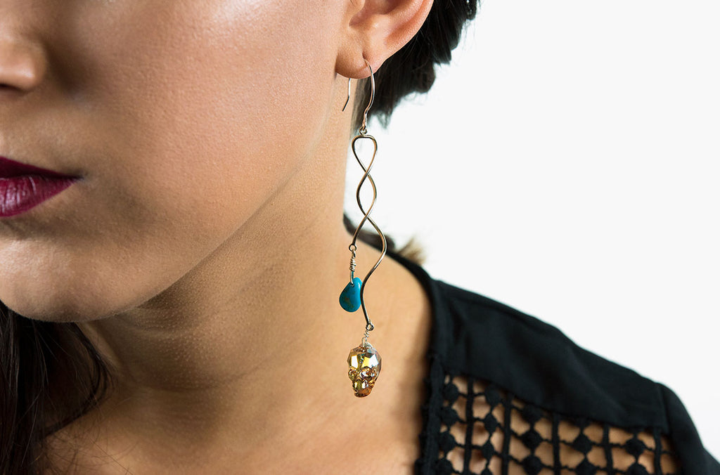 Swarovski skull earrings with turquoise dangle down to your shoulders on sterling silver swirls