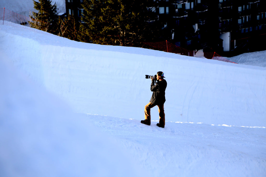 An image of a cameraman shooting amongst the slopes.