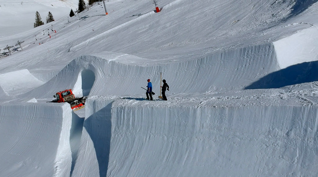 Image of a specialized machine clearing the slopes on which the shoot for this travel wallet took place.