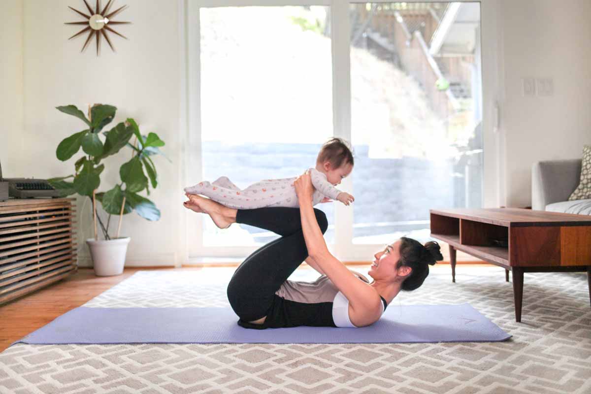 Woman doing yoga with her baby