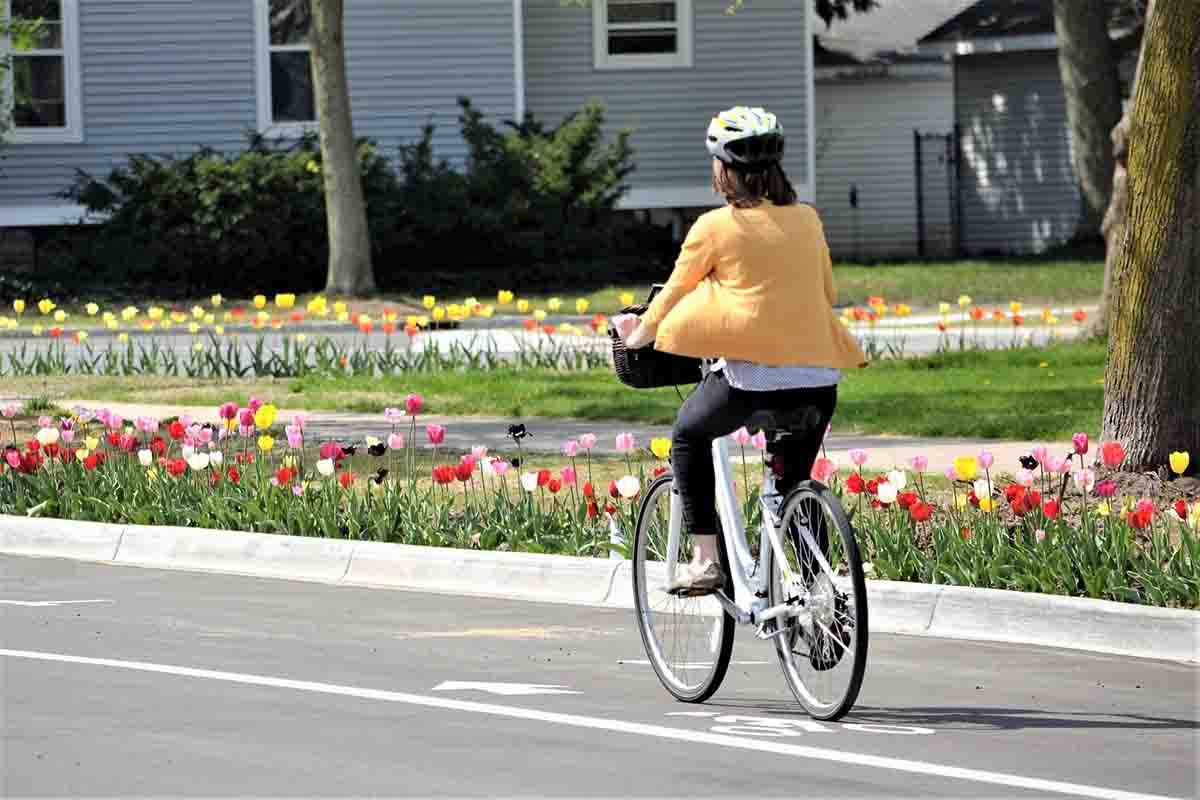 Woman riding bike down the road 