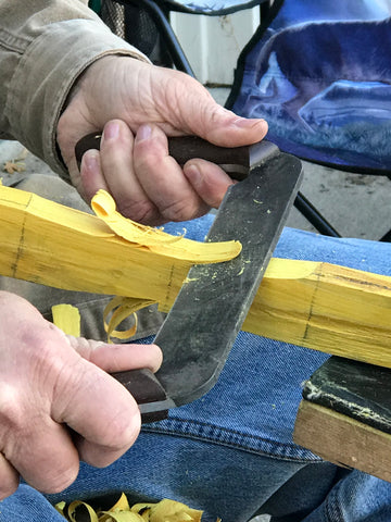 Using a draw knife to remove material from the bow