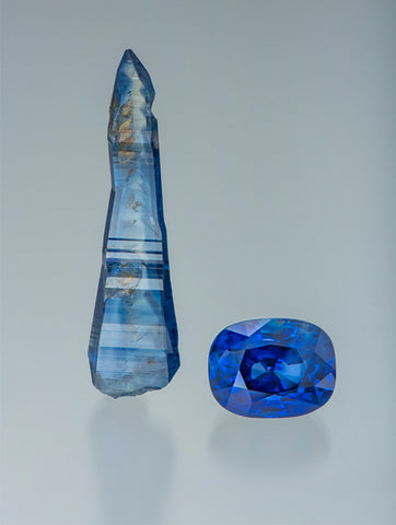 Sapphire crystal from Rakwana, Sri Lanka 5.94 cm in length and weighs approximately 49.99 ct. Facteted gem is 33.16 ct and came from the same pocket as the crystal. The faceted gem was cut from a 207 ct crystal. Courtesy of Dudley Blauwet Gems. Photo by Robert Weldon/GIA.