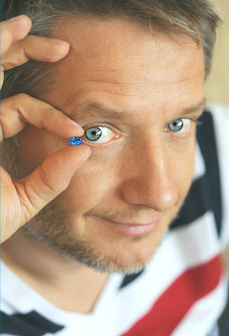 Here is Nomad's Mikola Kukharuk staring happily at the camera while holding a fine cobalt blue spinel