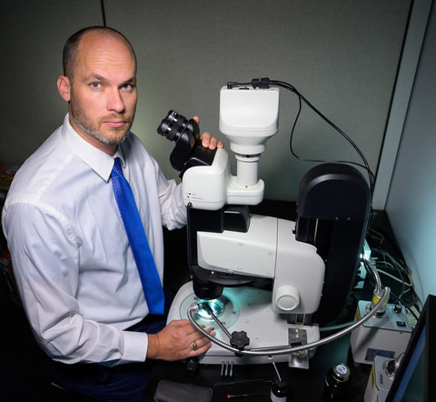 Nathan Renfro working with a Nikon SMZ25 microscope system. Photo by Kevin Schumacher, copyright/GIA
