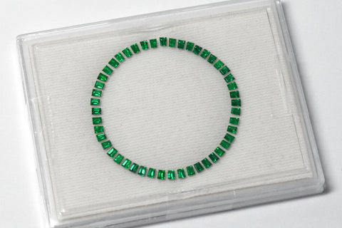 The final product of Swiss cutting, a perfect emerald ring that can be set around a watch dial.