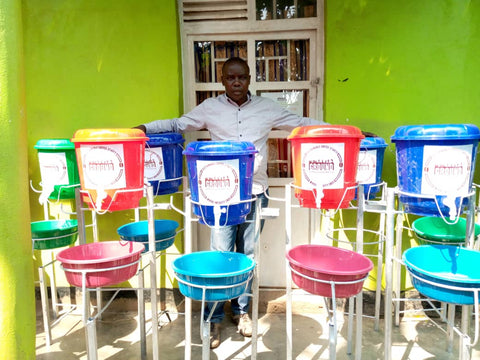 Herman with handwashing stations in Minova, DRC 2020