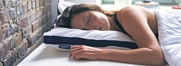 Lady sleeping on a Polysleep mattress with her head resting on a Polysleep pillow.