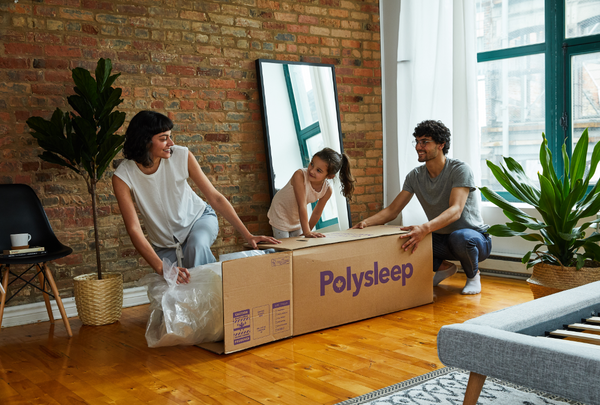 Woman unpacking her Polysleep mattress from its box
