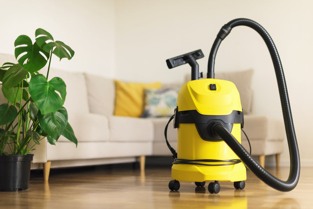 Mordern yellow vacuum cleaner in living room