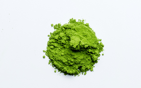 ceremonial matcha is the most vibrant green authentic quality, pictured against a white background, in a round pile