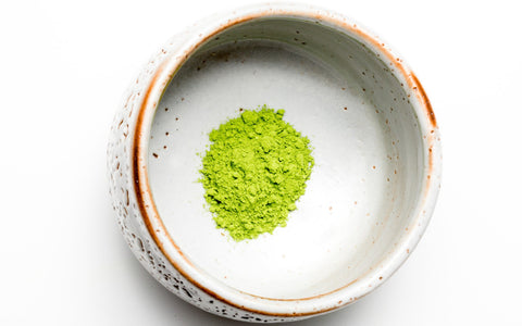 culinary grade matcha in a white matcha bowl chawan with golden edges, on a white background