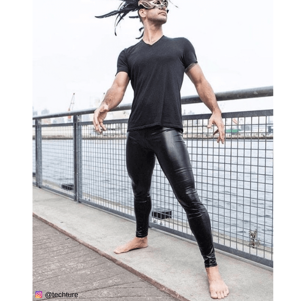 Young man in black mask and shiny male leggings by the water