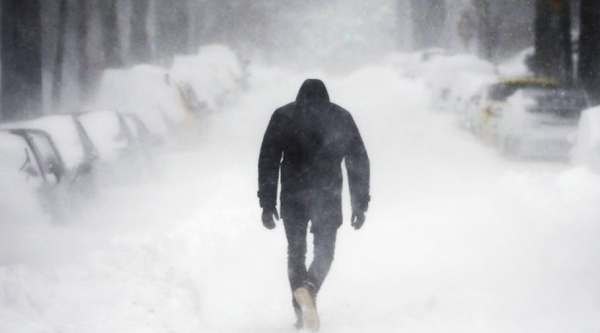 Man walking into a cold blizzard