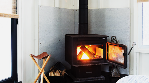 Wood stove in bright white room in the Scandinavian style